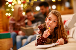 cute little girl writes letter to Santa Claus for Christmas